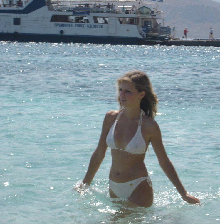 woman in see through top at the beach.