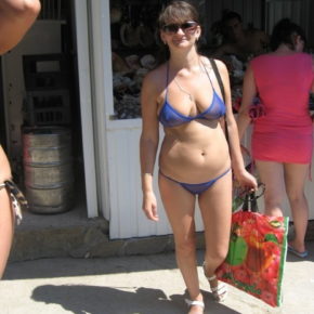 older lady walking around in public in a sheer bikini