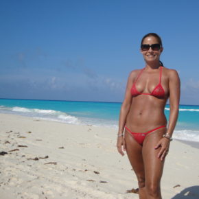 cute mom in slightly sheer bikini on a public beach.