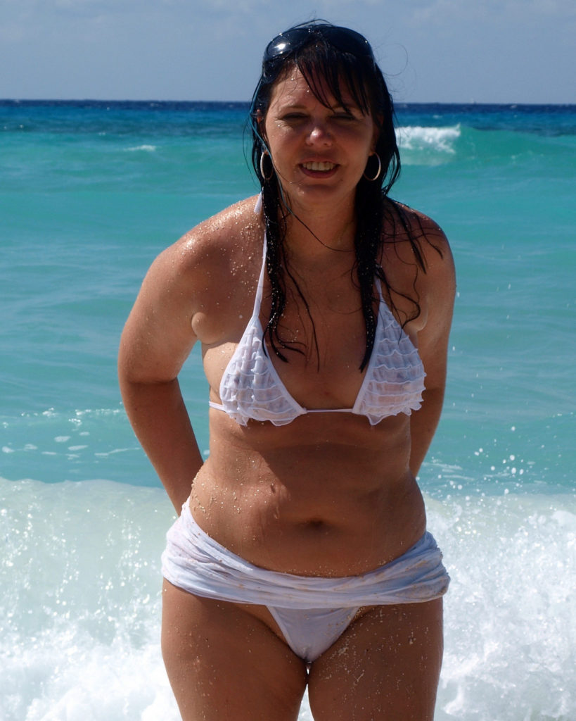 chubby milf in see through top at the beach
