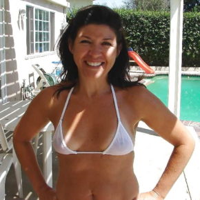 smiling mom in the backyard in see through bikini
